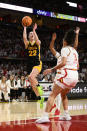 Iowa guard Caitlin Clark (22) goes to the basket against Maryland guard Lavender Briggs (3) during the first half of an NCAA college basketball game, Saturday, Feb. 3, 2024, in College Park, Md. (AP Photo/Nick Wass)
