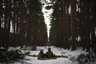Ukrainian servicemen stand at a position close to the border with Belarus, Ukraine, Wednesday, Feb. 1, 2023. Reconnaissance drones fly several times a day from Ukrainian positions across the border into Belarus, a close Russian ally, scouring for signs of trouble on the other side. Ukrainian units are monitoring the 1,000-kilometer (650-mile) frontier of marsh and woodland for a possible surprise offensive from the north, a repeat of the unsuccessful Russian thrust towards Kyiv at the start of the war nearly a year ago. (AP Photo/Daniel Cole)