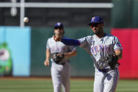 Texas Rangers second baseman Marcus Semien throws to first base for the out on Oakland Athletics' JJ Bleday during the fourth inning in the second baseball game of a doubleheader Wednesday, May 8, 2024, in Oakland, Calif. (AP Photo/Godofredo A. Vásquez)