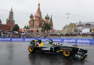 Formula One Team Lotus driver Karun Chandhok of India drives past St. Basils cathedral during the "Moscow City Racing" show on July 17, 2011 in central Moscow. AFP PHOTO / NATALIA KOLESNIKOVA (Photo credit should read NATALIA KOLESNIKOVA/AFP/Getty Images)