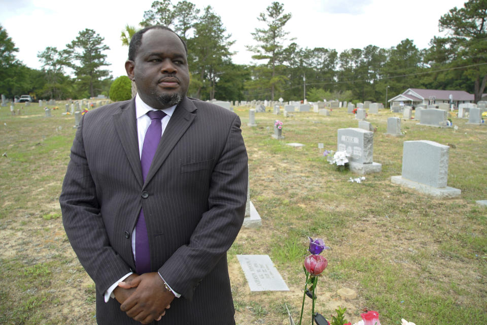 Funeral director Shawn Troy stands for a portrait at Hillcrest Cemetery outside Mullins, S.C., on Monday, May 24, 2021. His father, William Penn Troy Sr., who developed the cemetery and is buried there, died of COVID-19 in August 2020, one of many Black funeral directors to succumb during the pandemic. (AP Photo/Allen G. Breed)