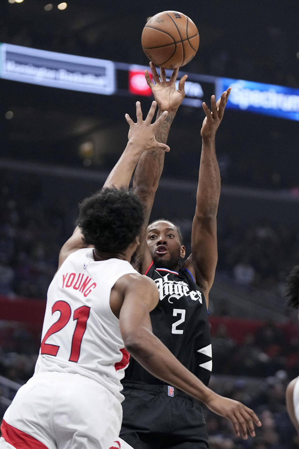 Los Angeles Clippers forward Kawhi Leonard, right, shoots as Toronto Raptors forward Thaddeus Young defends during the first half of an NBA basketball game Wednesday, Jan. 10, 2024, in Los Angeles. (AP Photo/Mark J. Terrill)