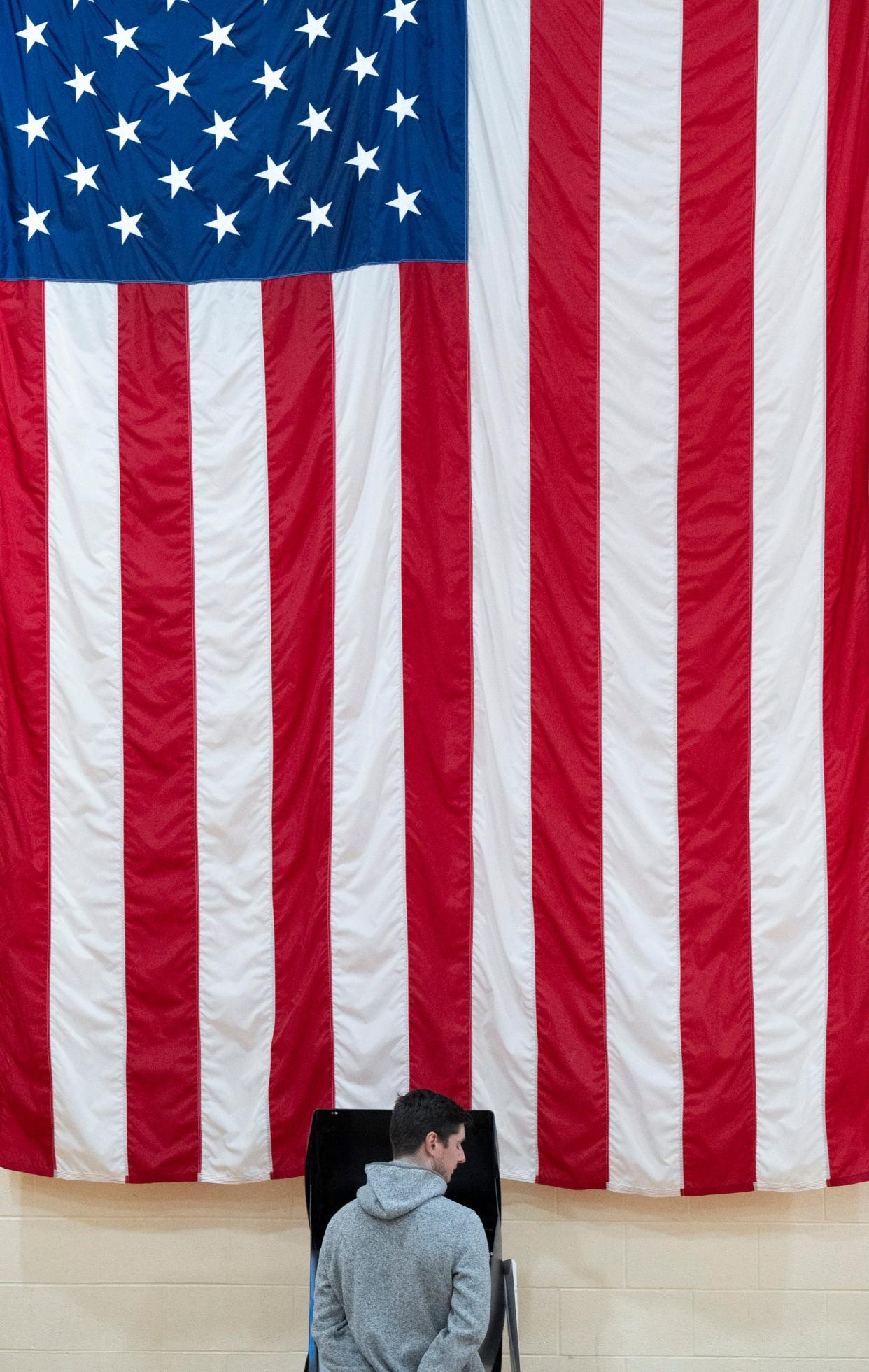 Dylan Bryan casts his vote during the midterm elections at the Annunciation Greek Orthodox Cathedral on Tuesday night, in Columbus, Ohio on Nov 4, 2022.