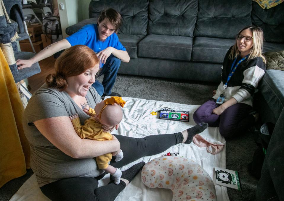 Mariah Denis, left, holds her newborn daughter Maelynn Spencer, 1 month, with dad Cody Spencer, center, and the home visitor Erin Rosinsky-Gauthier, Thursday, April 4, 2024, in Two Rivers, Wis.