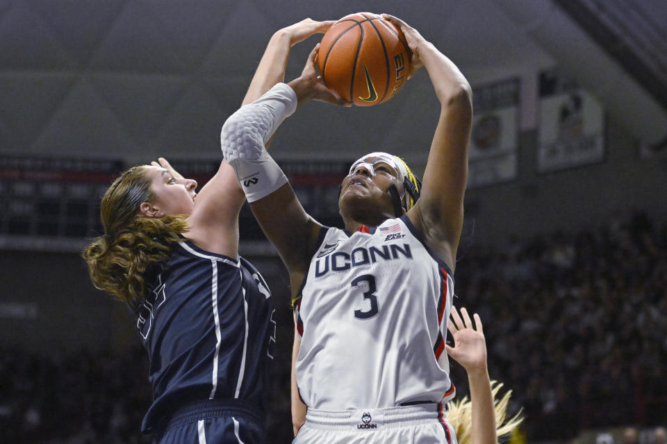 UConn's Aaliyah Edwards, right, is fouled by Butler's Sydney Jaynes in the first half of an NCAA college basketball game, Saturday, Jan. 21, 2023, in Storrs, Conn. (AP Photo/Jessica Hill)