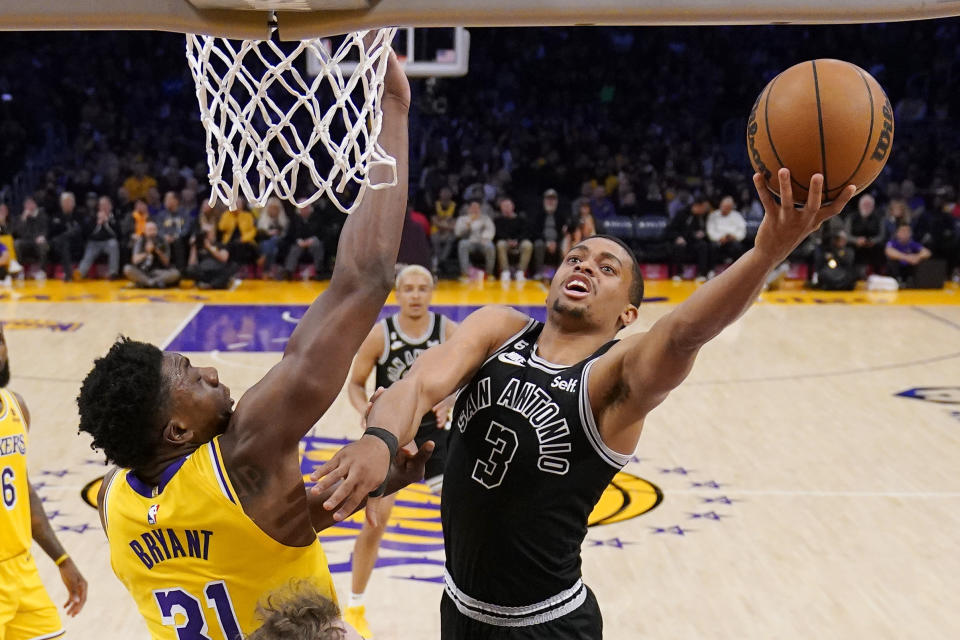 San Antonio Spurs forward Keldon Johnson, right, shoots as Los Angeles Lakers center Thomas Bryant defends during the first half of an NBA basketball game Wednesday, Jan. 25, 2023, in Los Angeles. (AP Photo/Mark J. Terrill)
