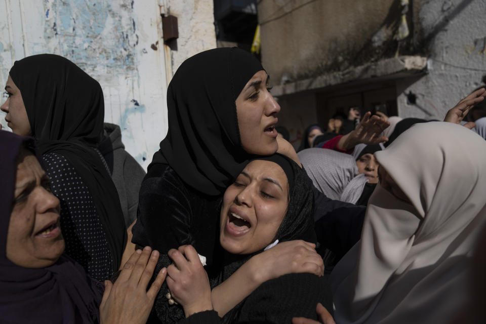 Amal and Amani Abu Junaid sisters of Ahmed Abu Junaid, 21 cry during his funeral in the West Bank refugee camp of Balata, Nablus, Thursday, Jan. 12, 2023. During a pre dawn Israeli military incursion into the hardscrabble Balata refugee camp, Israeli forces shot Abu Junaid in the head and he died several hours later, the Palestinian Health Ministry said. (AP Photo/Nasser Nasser)