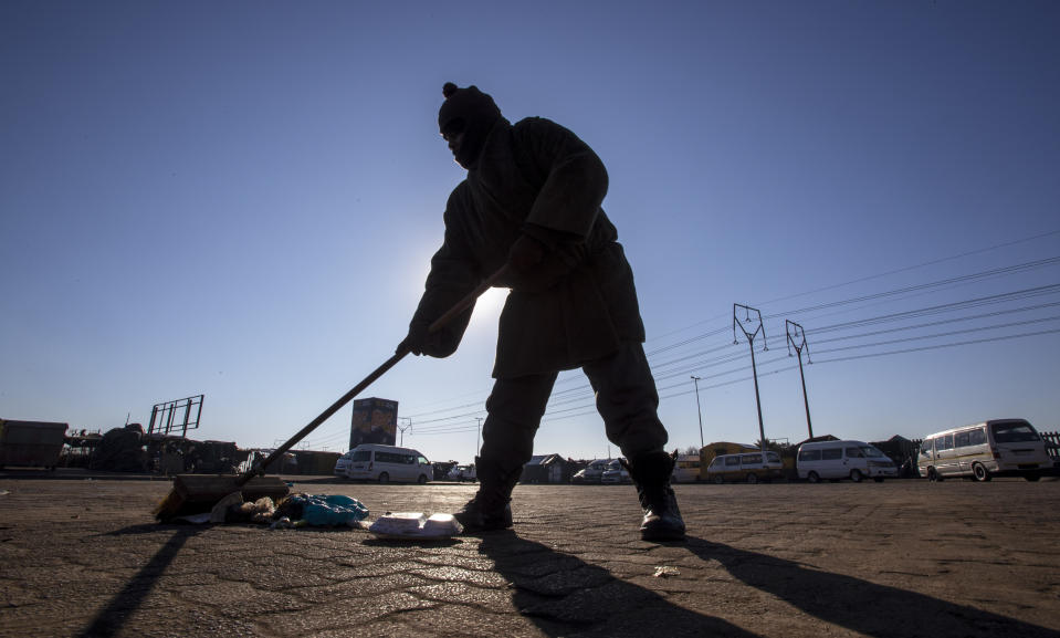 A worker sweeps the floor at a taxi rank in Katlehong, South Africa, Monday, June 22, 2020, as taxi drivers affiliated to the SA National Taxi Council (Santaco) protested against what it believes to be insufficient government relief offered to the industry. South Africa’s largest city, Johannesburg, has been hit by a strike by mini-bus taxis, preventing many thousands of people from getting to work on Monday, as the country reopens its economy even as cases of COVID-19 are increasing. (AP Photo/Themba Hadebe)