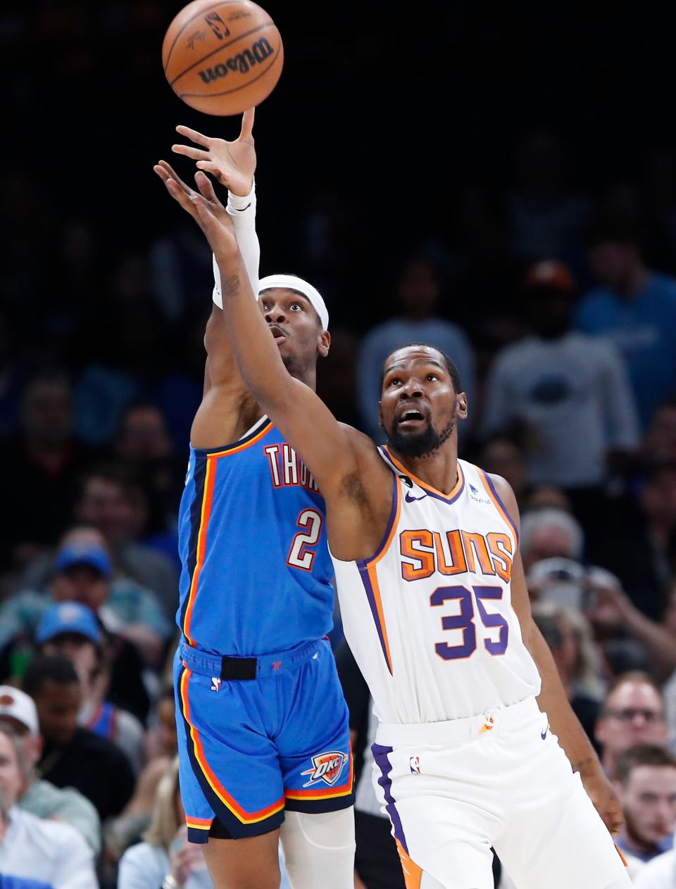 Phoenix Suns forward Kevin Durant (35) and Oklahoma City Thunder guard Shai Gilgeous-Alexander (2) reach for loose ball during the first quarter at Paycom Center on April 02, 2023, in Oklahoma City.