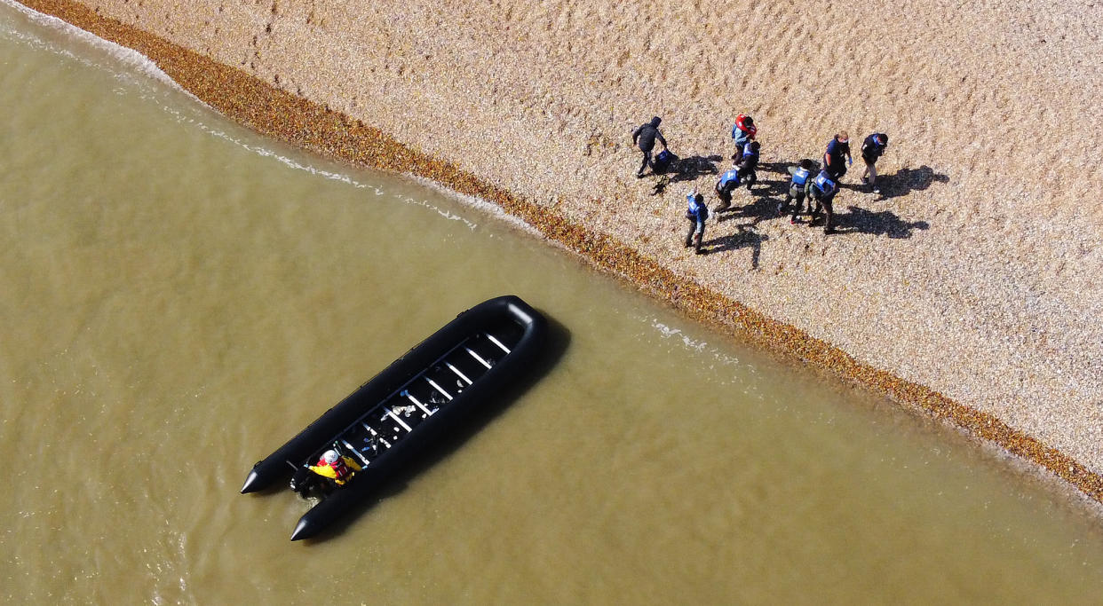 A group of people thought to be migrants are escorted to shore in Kingsdown, Kent, after being intercepted by an RNLI crew following a small boat incident in the Channel. Picture date: Tuesday September 7, 2021.