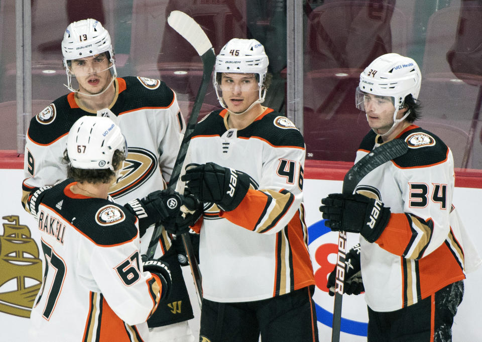 Anaheim Ducks' Trevor Zegras (46) celebrates with teammates Rickard Rakell (67), Troy Terry (19) and Jamie Drysdale (34) after scoring against the Montreal Canadiens during the second period of an NHL hockey game, Thursday, Jan. 27, 2022 in Montreal. (Graham Hughes/The Canadian Press via AP)
