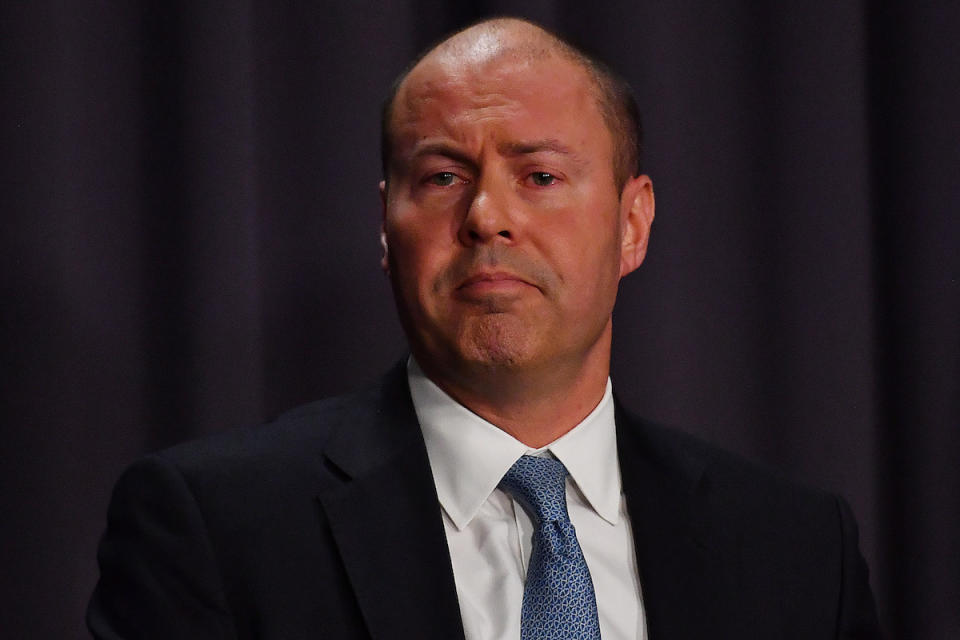 Headshot of Australian Treasury Josh Frydenberg on dark background as he hands down super changes