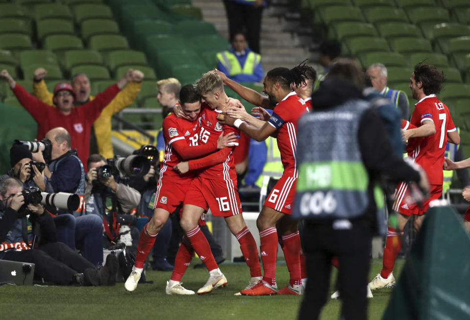 Wales' Harry Wilson, center, celebrates scoring his side's first goal of the game during the UEFA Nations League soccer match between Republic of Ireland and Wales at The Aviva Stadium, Dublin, Tuesday, Oct. 16, 2018. (Liam McBurney/PA via AP)