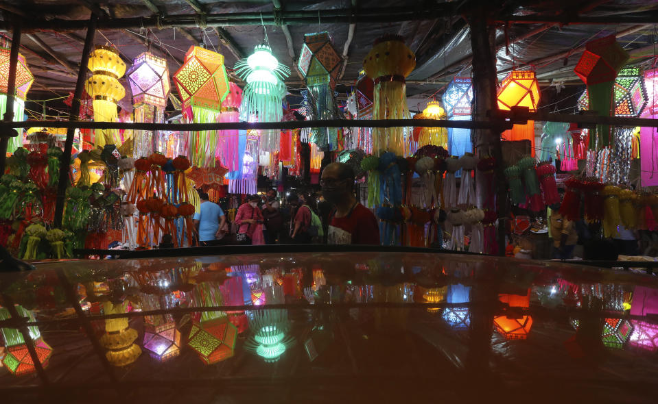 People shop for lanterns at a roadside stall ahead of Diwali, the Hindu festival of lights, in Mumbai, India, Saturday, Nov. 7, 2020. Diwali will be celebrated on Nov. 14. (AP Photo/Rafiq Maqbool)