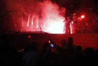 Protesters clash with riot police on the steps of the Serbian parliament during a protest in Belgrade, (AP Photo/Darko Vojinovic)