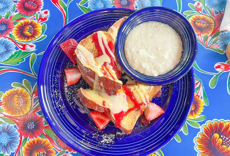 An order of stuffed French toast on challah bread with a side of grits on opening day of the Flying Biscuit restaurant location at Epps Bridge Road in Athens, Ga. on Monday, July 3, 2023.