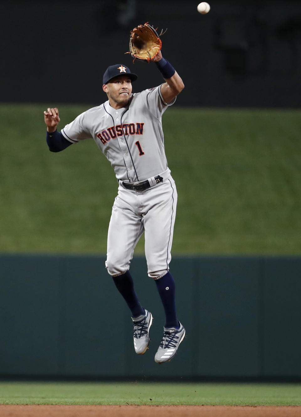 Houston Astros shortstop Carlos Correa leaps to catch a line drive by St. Louis Cardinals' Tyler O'Neill to end the sixth inning of a baseball game Friday, July 26, 2019, in St. Louis. (AP Photo/Jeff Roberson)