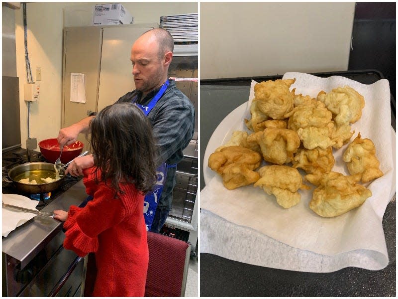 A father and daughter fry bimuelos, a traditional Sephardic Hanukkah food.