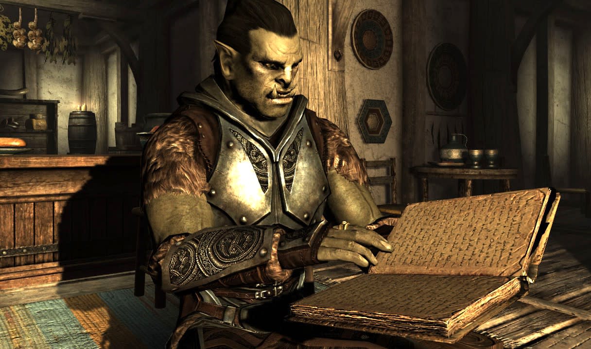  An orc reading a book in The Elder Scrolls V: Skyrim. 