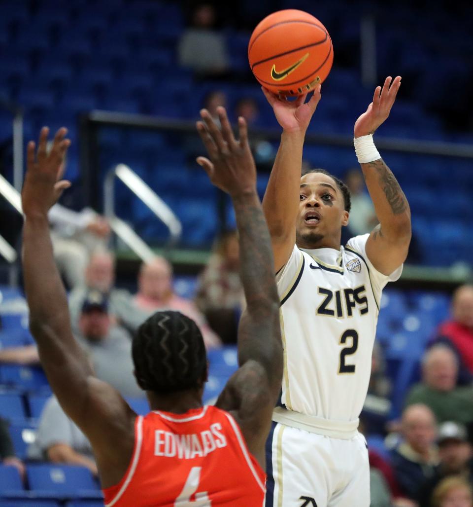 Akron Zips guard Greg Tribble shoots over Bowling Green guard PJ Edwards during the first half, Friday, Jan. 5, 2024.