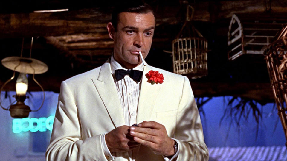  Sean Connery's James Bond looks at someone off camera in Goldfinger. 