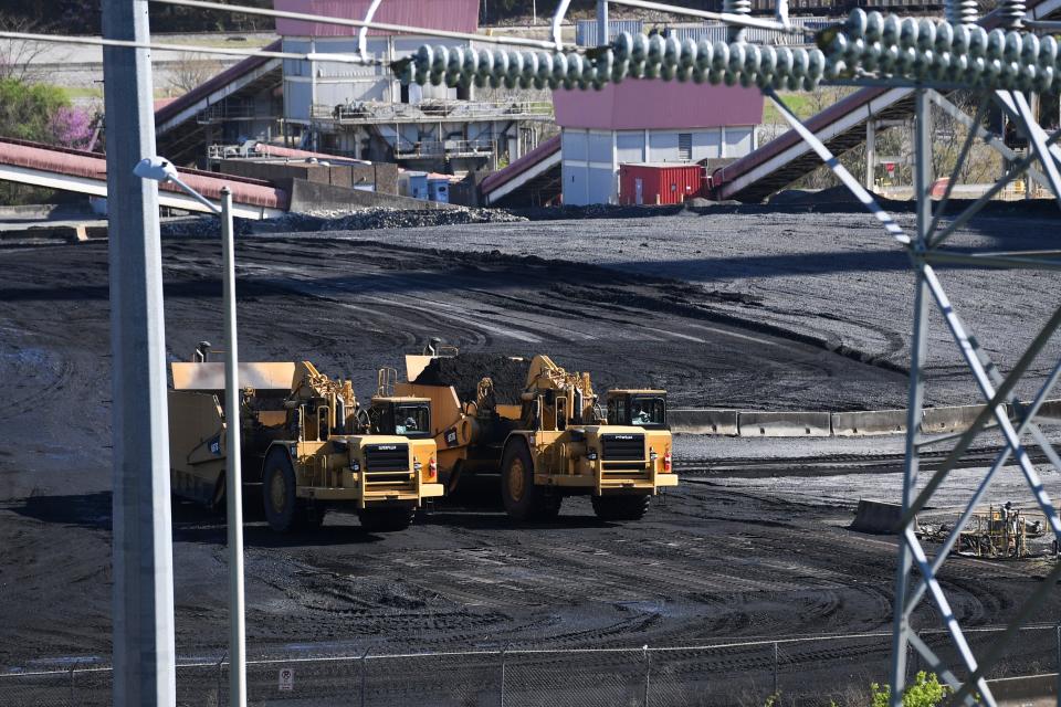 Heavy machinery moves coal at the Bull Run Fossil Plant in March 2023.