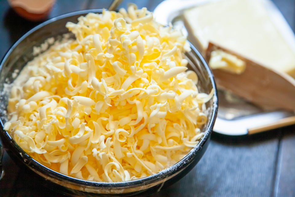 Grated cold butter in a mixing bowl