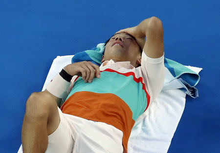 Tennis - Australian Open - Quarter-final - Melbourne Park, Melbourne, Australia, January 23, 2019. Japan's Kei Nishikori reacts after sustaining an injury during the match against Serbia's Novak Djokovic. REUTERS/Adnan Abidi