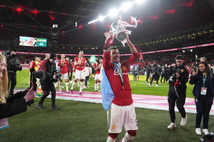 Manchester United's Lisandro Martinez celebrates with the trophy after the English League Cup final soccer match between Manchester United and Newcastle United at Wembley Stadium in London, Sunday, Feb. 26, 2023. (AP Photo/Alastair Grant)