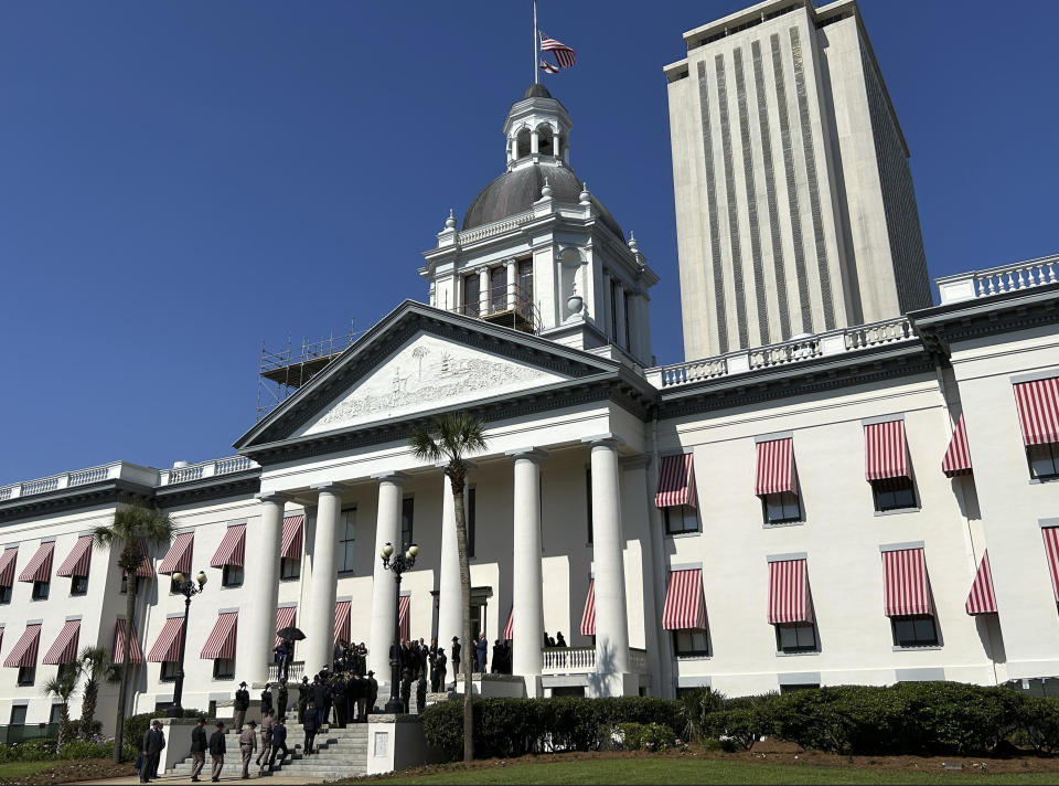 Mourners line up outside the historic Old Capitol building in Tallahassee, Fla., on Friday morning, April 26, 2024, for a memorial service for former U.S. Sen. Bob Graham, who died April 16. Graham, a Democrat, also served as Florida governor before his election to the U.S. Senate. (AP Photo/Brendan Farrington)