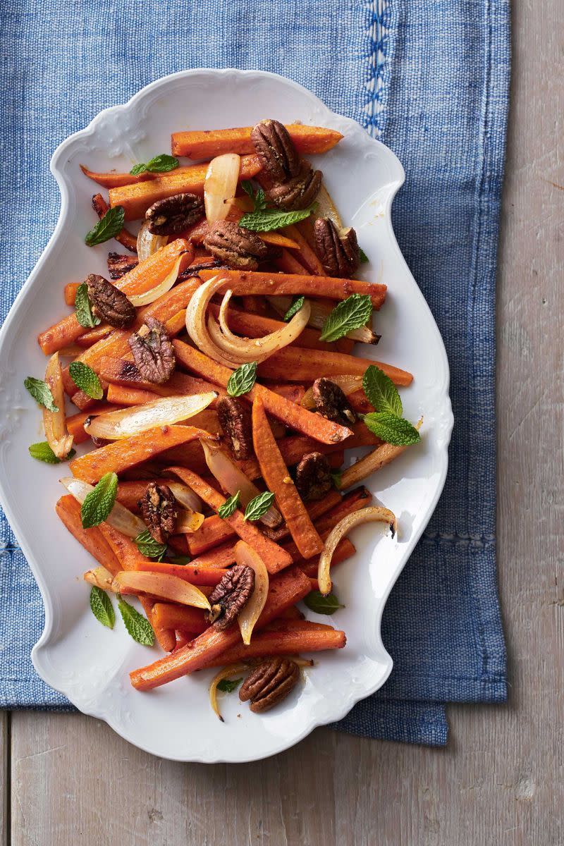 <p>Fresh mint brings a bright note to hearty root vegetables garnished with spiced pecans. </p><p><strong><a href="https://www.countryliving.com/food-drinks/recipes/a5079/roasted-sweet-potatoes-carrots-recipe-clx1113/" rel="nofollow noopener" target="_blank" data-ylk="slk:Get the recipe for Roasted Sweet Potatoes and Carrots;elm:context_link;itc:0;sec:content-canvas" class="link ">Get the recipe for Roasted Sweet Potatoes and Carrots</a>.</strong> </p>