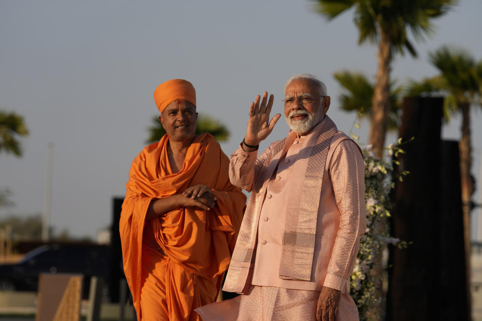 Indian Prime Minister Narendra Modi, right, waves as he arrives for the opening ceremony of the first stone-built Hindu temple in the Middle East, belonging to Bochasanwasi Akshar Purushottam Swaminarayan Sanstha in Abu Mureikha, 40 kilometers (25 miles) northeast of Abu Dhabi, United Arab Emirates, Wednesday, Feb. 14, 2024. (AP Photo/Kamran Jebreili)