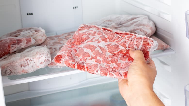 taking frozen meat from freezer