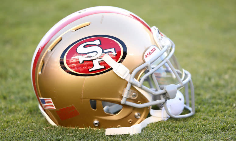 San Francisco 49ers helmet sits on the turf.