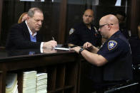 <p>Film producer Harvey Weinstein signs papers inside Manhattan Criminal Court during his arraignment in Manhattan in New York, May 25, 2018. (Photo: Jefferson Siegel Pool via Reuters) </p>