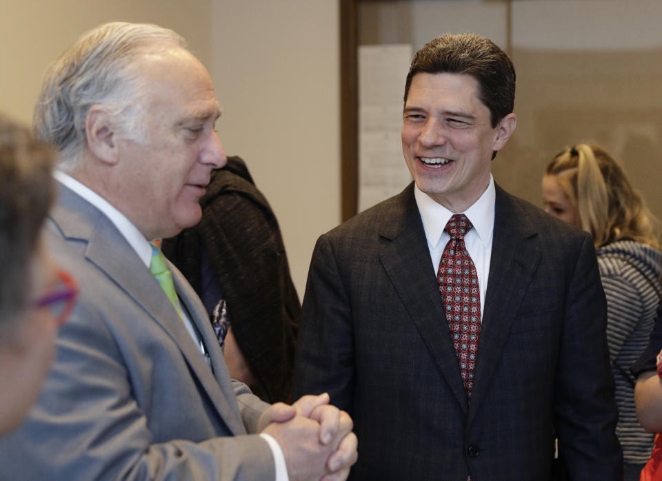 Brett Busby, right, appointed by Texas Gov. Greg Abbott to fill a vacancy on the Texas Supreme Court, visits with Sen. Kirk Watson, D-Austin, following his Senate confirmation hearing, Thursday, March 7, 2019, in Austin, Texas. Barely three months after Texas Democrats showed signs of cracking Republican dominance in Texas elections, Abbott is using the power of his office to stem that tide by appointing Republican judges who had been rejected by voters to new positions on the bench. (AP Photo/Eric Gay)