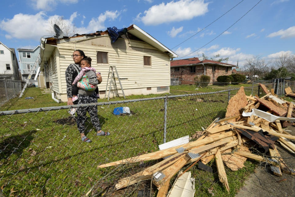 Dominique Hammond and her daughter Analise Hammond are seen outside their home in North Nashville following devastating tornadoes.