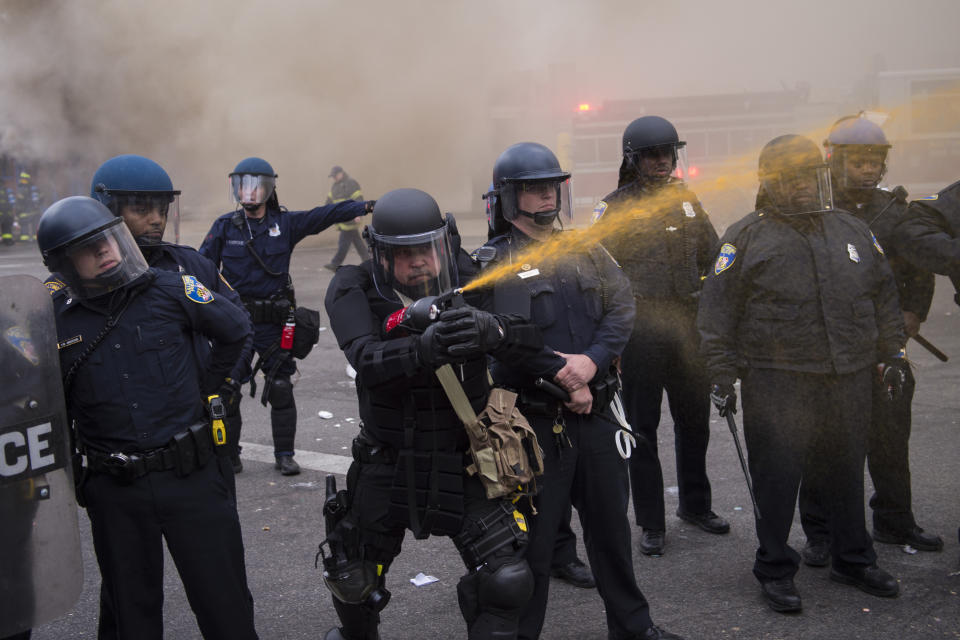 BALTIMORE, MD - APRIL 27: Officers pepper spray people near West North Avenue and Pennsylvania Avenue during a protest for Freddie Gray in Baltimore, MD on Monday April 27, 2015. Gray died from spinal injuries about a week after he was arrested and transported in a police van. (Photo by Jabin Botsford/The Washington Post via Getty Images)