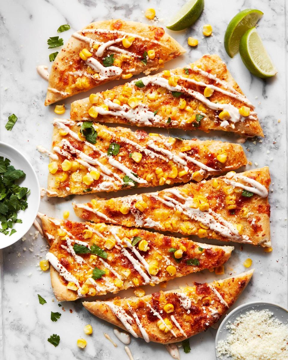 flatbread topped with corn, cheese, and cilantro