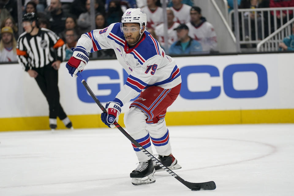 New York Rangers defenseman K'Andre Miller passes the puck during the first period of the team's NHL hockey game against the San Jose Sharks in San Jose, Calif., Saturday, Nov. 19, 2022. (AP Photo/Jeff Chiu)