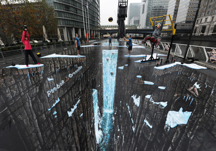 Commercial Photo - Reebok CrossFit, a revolutionary strength and conditioning programme, teamed up with artists 3D Joe and Max to break the Guinness World Record for the largest ever 3D street art. The painting measured an impressive 1,160.4 square metres and was unveiled at West India Quays, Canary Wharf, London, Thursday, Nov. 17, 2011. The public were invited to take part in a Reebok CrossFit WOD (workout of the day) on the spectacular artwork. ( Gary Prior/Reebok CrossFit via AP Images)
