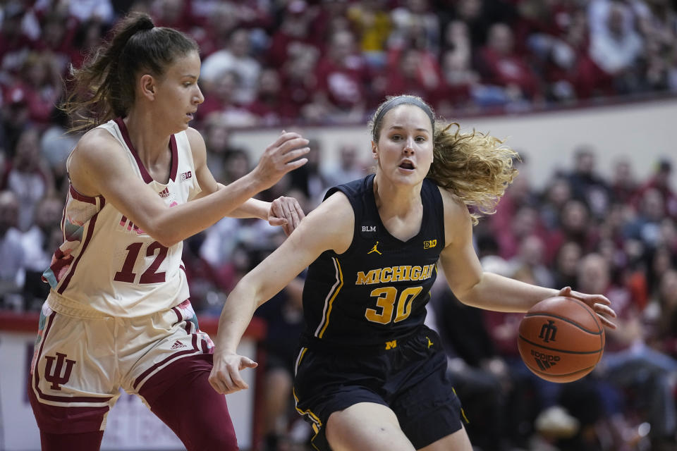 Michigan's Elise Stuck (30) is defended by Indiana's Yarden Garzon (12) during the first half of an NCAA college basketball game, Thursday, Feb. 16, 2023, in Bloomington, Ind. (AP Photo/Darron Cummings)