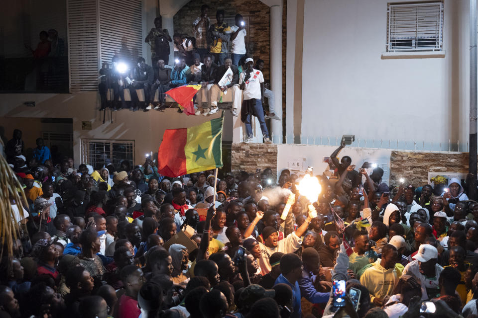 Supporters celebrate the release of Senegal's top opposition leader Ousmane Sonko and his key ally Bassirou Diomaye Faye outside Sonko's home in Dakar, Senegal, Thursday, March 14, 2024. Sonko had been in prison since July 2023 and has fought a prolonged legal battle to run for president in the March 24 election.(AP Photo/Sylvain Cherkaoui)