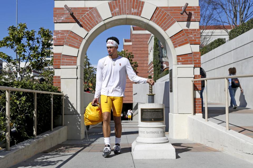 USC quarterback Malachi Nelson carries his pads and walks out to spring football practice