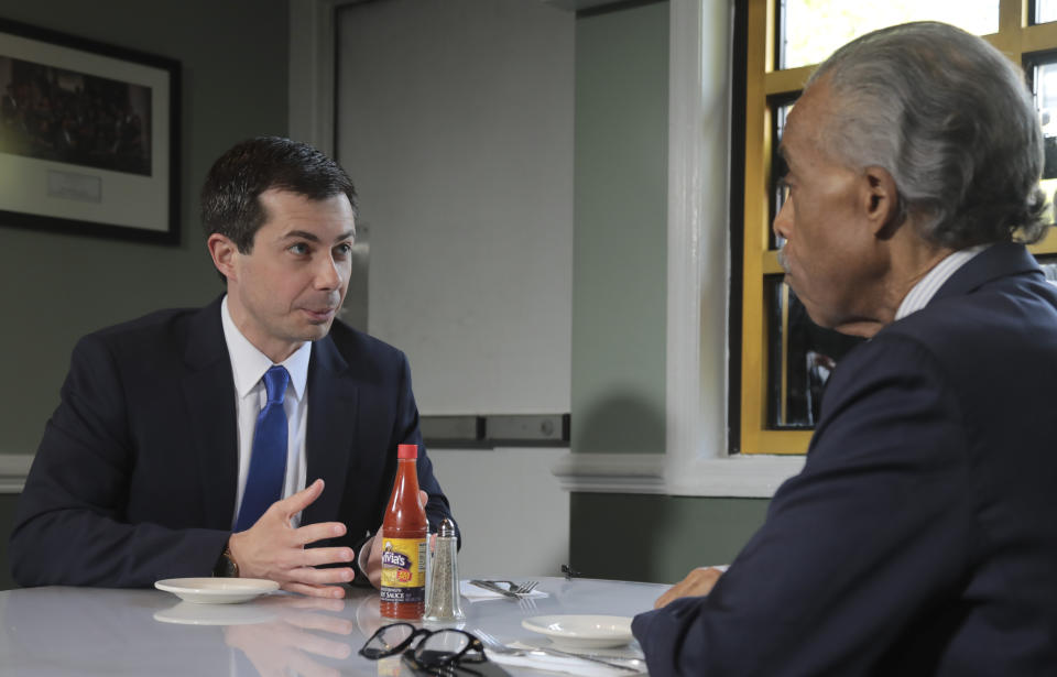 Democratic presidential candidate Mayor Pete Buttigieg, from South Bend, Indiana, and civil rights leader Rev. Al Sharpton, right, President of National Action Network, hold a lunch meeting at Sylvia's Restaurant in Harlem, New York, Monday, April 29, 2019. (AP Photo/Bebeto Matthews, Pool)