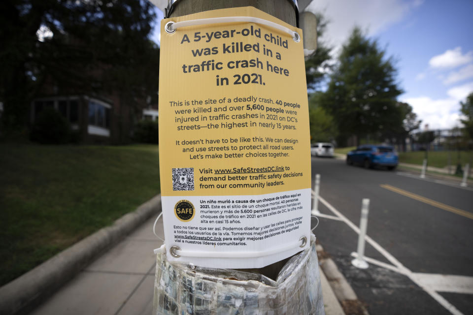 A sign is mounted to a pole near an intersection where 5-year-old Allie Hart was struck and killed in 2021 by a driver while riding her bicycle in a crosswalk, as seen Monday, Sept. 11, 2023, in Washington. (AP Photo/Mark Schiefelbein)