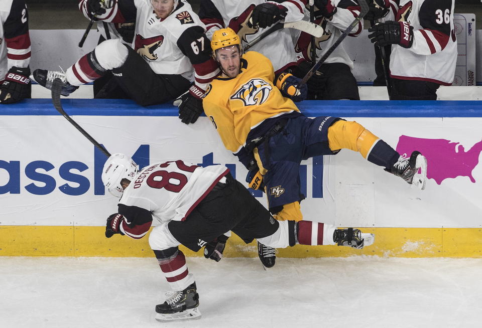 Nashville Predators' Kyle Turris (8) is checked by Arizona Coyotes' Jordan Oesterle (82) during the first period NHL qualifying round game action in Edmonton, on Sunday, Aug. 2, 2020. (Jason Franson/The Canadian Press via AP)