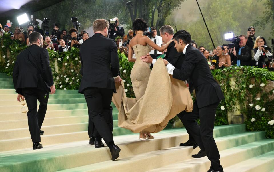 Tyla is carried up the stairs at the Met Gala in her Balmain dress