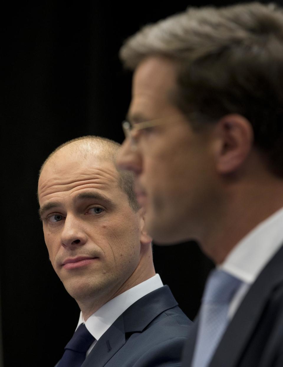 Caretaker Prime Minister Mark Rutte, right, and Labor Party Leader Diederik Samsom, left, are seen during a joint press conference in The Hague, Netherlands, Monday Oct. 29, 2012. The Netherlands is close to getting a new coalition government after lawmakers from the two biggest parties approved a policy deal hammered out by their leaders. Rutte, leader of the pro-free market VVD party, and center-left Labor Party chief Samsom have been negotiating behind closed doors for weeks to resolve policies for their proposed coalition. (AP Photo/Peter Dejong)