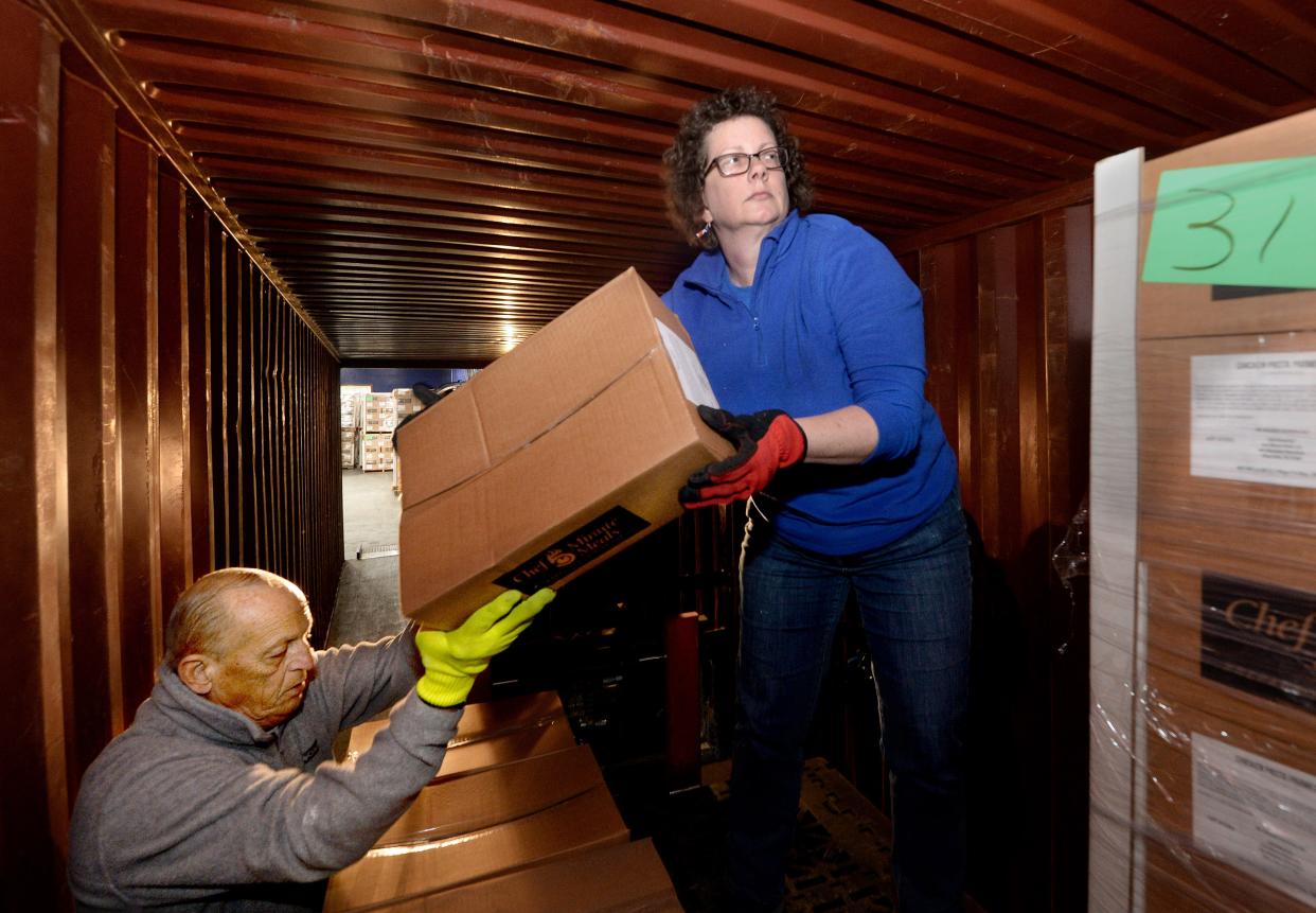 Inventory specialist Sarah Frazee, right, and Chatham operations manager Brad Walton stack boxes of donations into a truck for earthquake victims in Turkey at the Midwest Mission Distribution Center in Pawnee on Friday March 10, 2023.